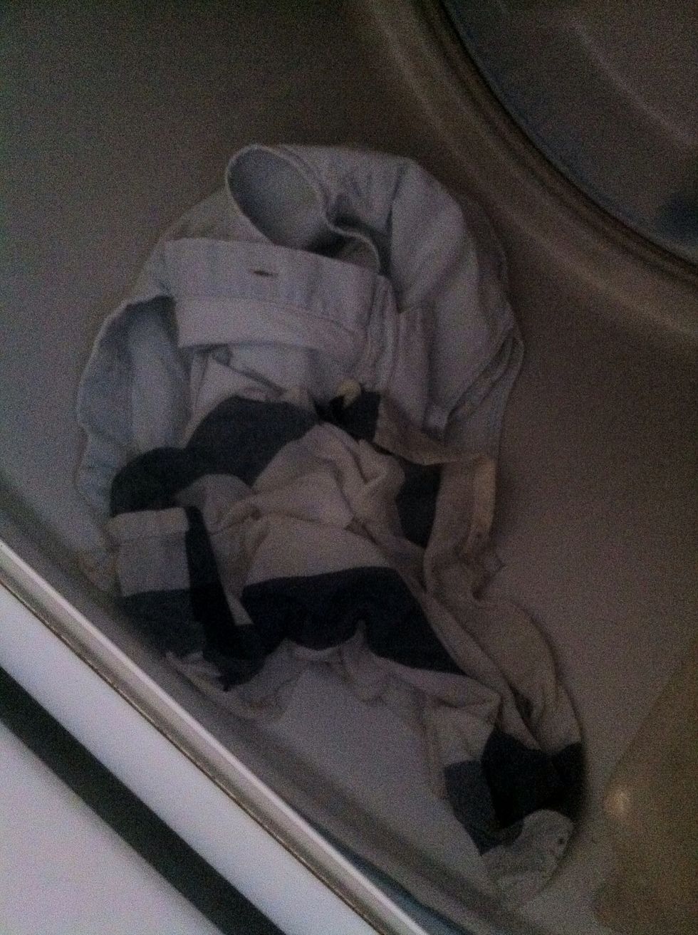 Throw both the cloth and piece of clothes into a dryer :)