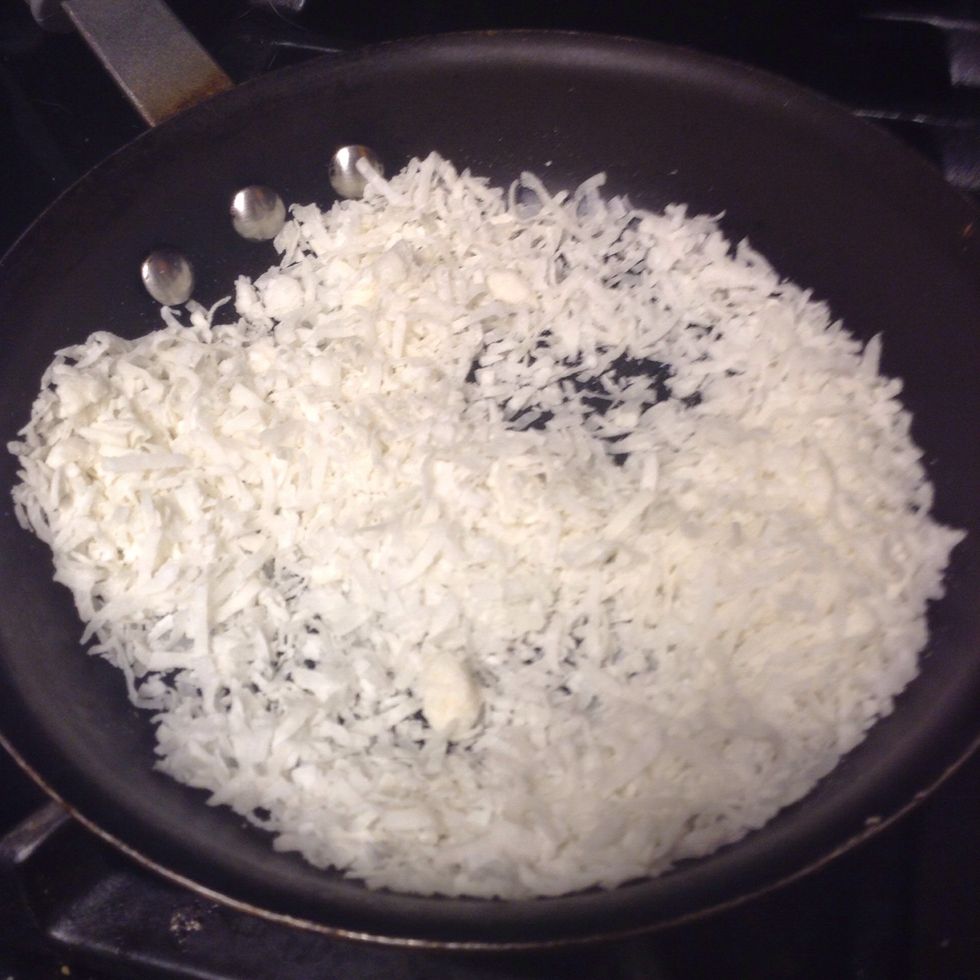 Throw coconut in a pan for about a minute. It doesn't necessarily need to brown.