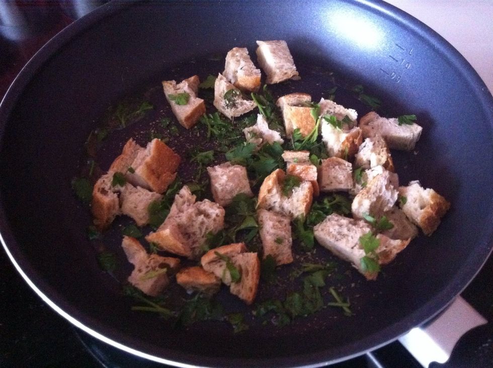 Throw in parsley, chunks of bread and oregano. Fry until bread reaches the familiar brown color.