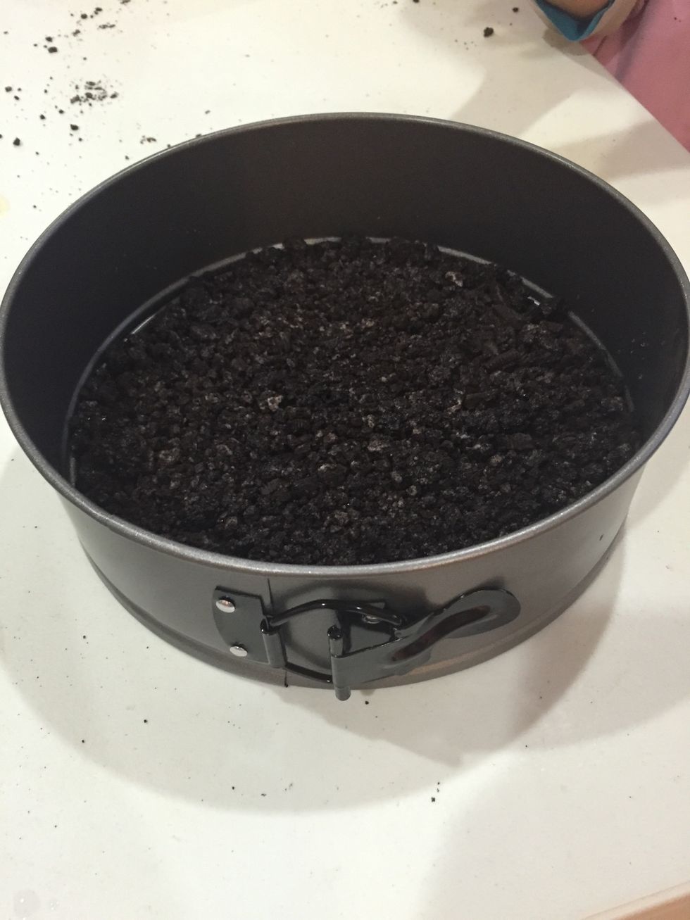 Throw in the crushed Oreos and even it out into the 8-1/2" spring-form. Place in the fridge for about 20 minutes or when you think the base will be ready.