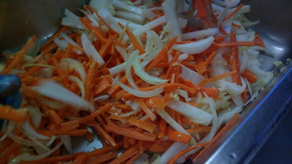 Throw it all in to a giant mixing bowl and play play play. Make sure you get all the garlic, ginger and salt all through those carrots.