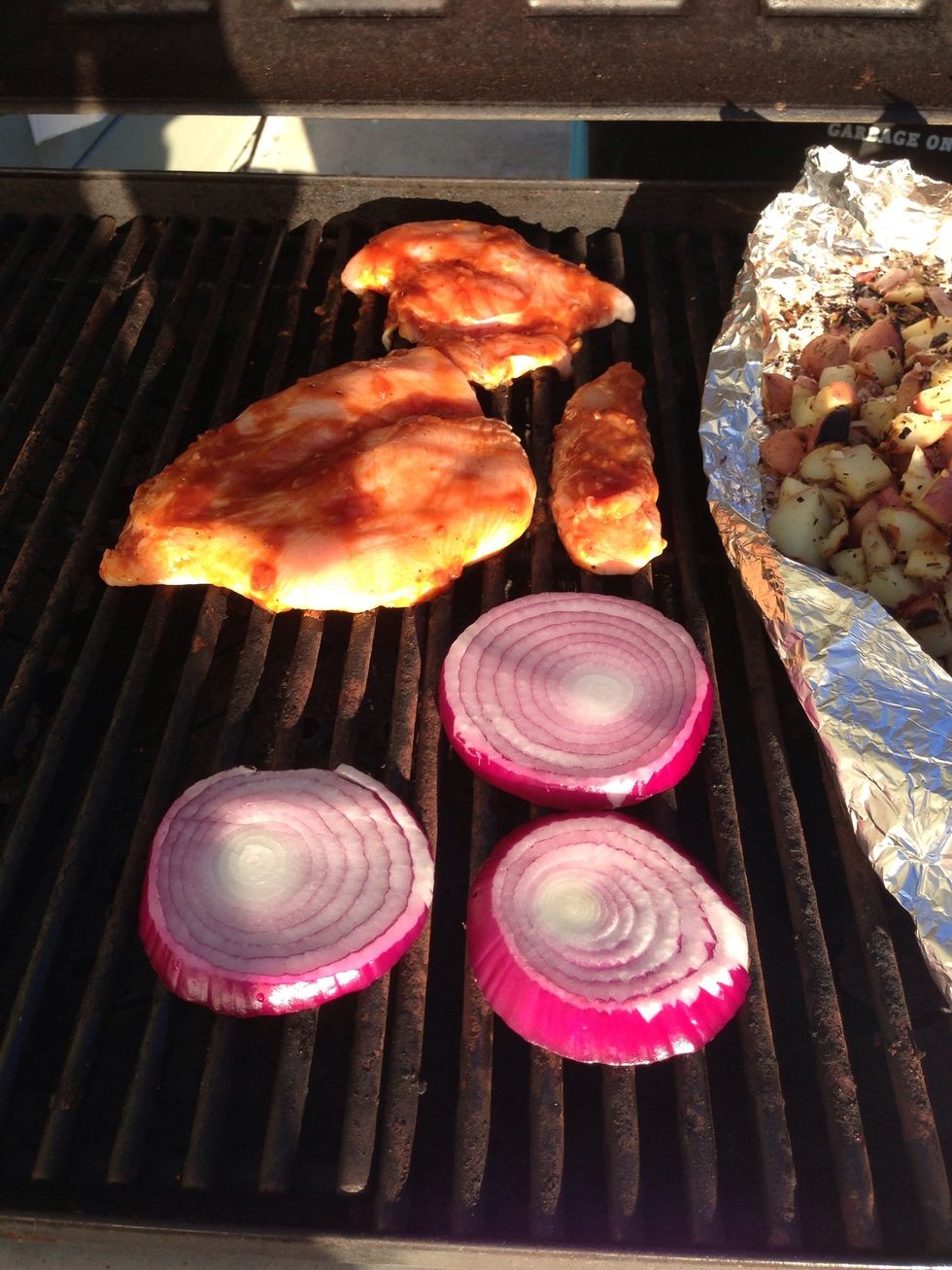 Throw the chicken and onions on the grill.
