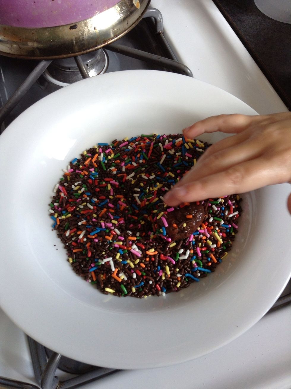 Throw the chocolate ball on the sprinklers and spin it around until it covers the whole thing.