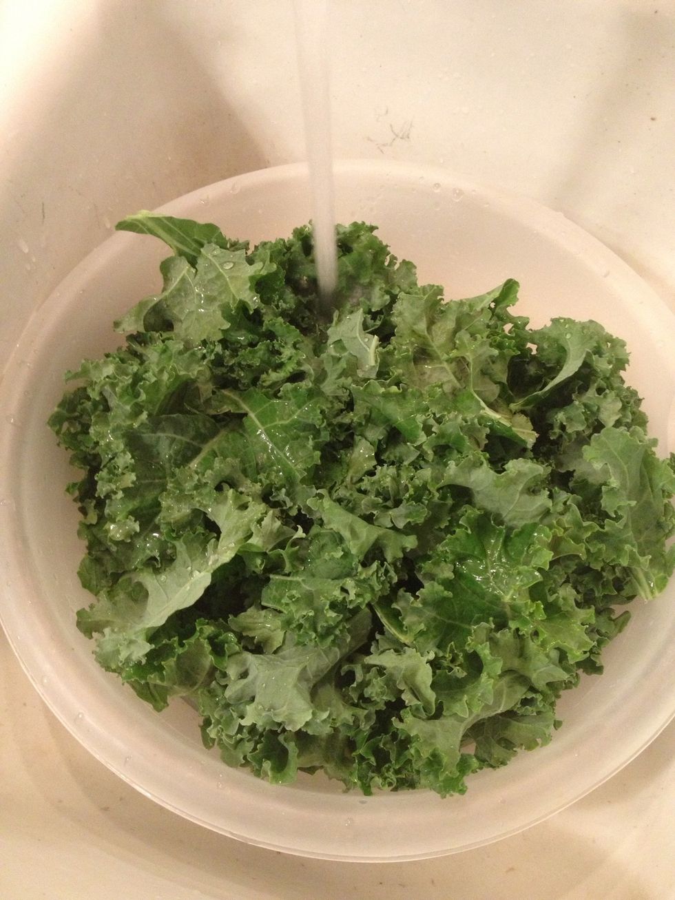Throw the kale leaves into a large bowl and fill with fresh clean water. Shake it around, drain and repeat. Do this 3 times...but the 3rd time...