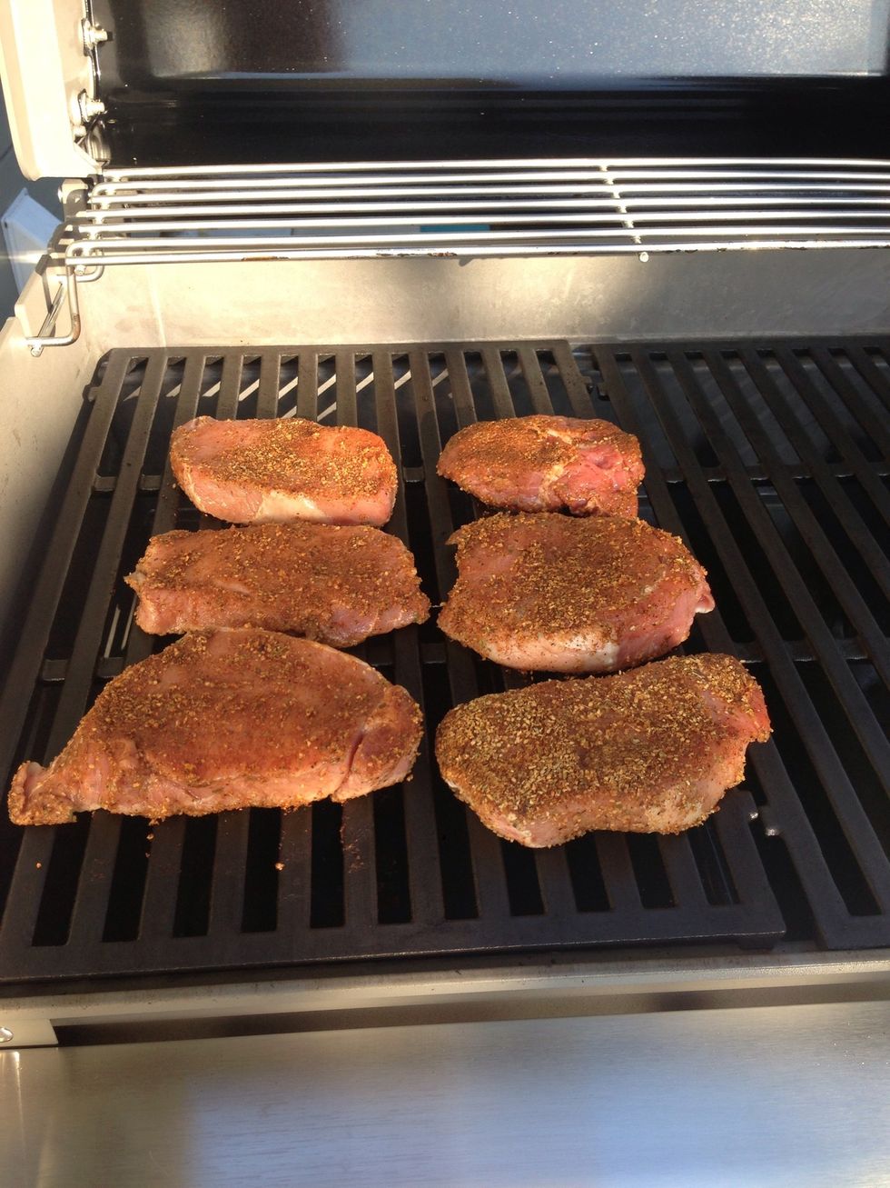 Throw the pork chops on the grill and cover the lid.