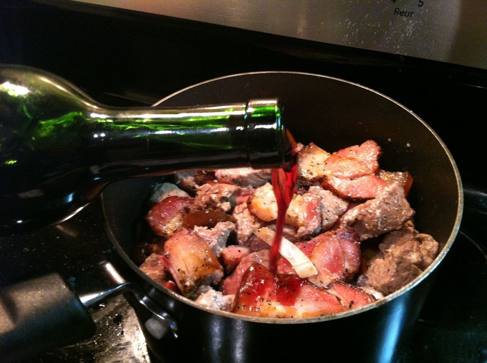 Throw the reserved and cut beef cubes back in the pot. Pour coke and bottle of wine until beef is covered by 1 inch of liquid. Add water if needed