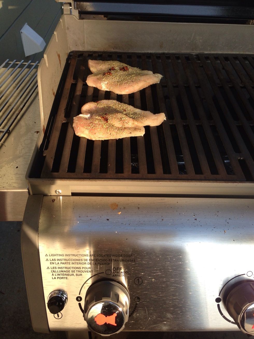 Throw your chicken on the grill. After 4 mins, flip the chicken over and cook the other side for 4 mins.