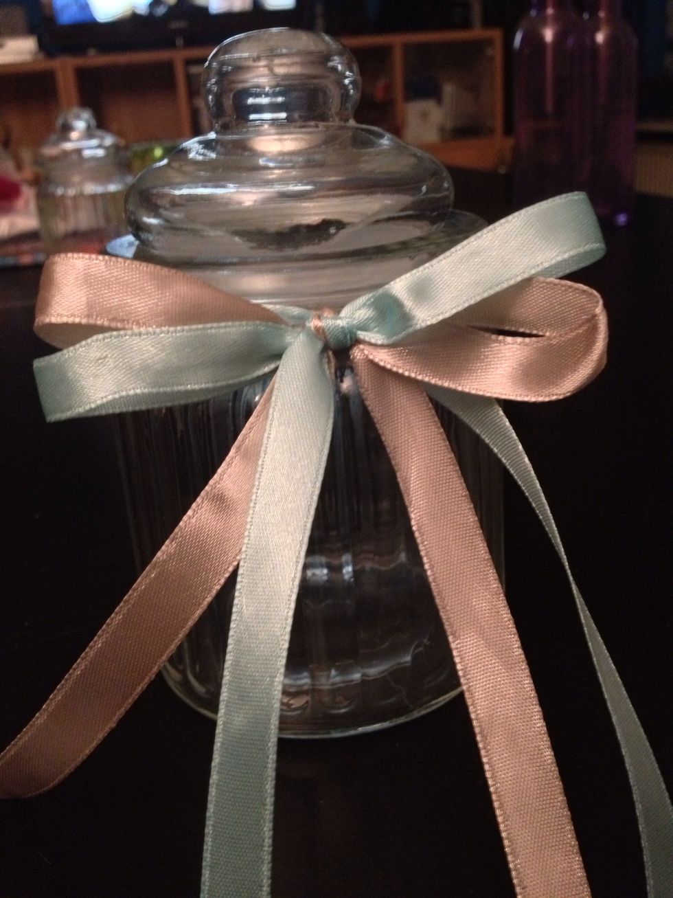 Tie a bow with the 2 ribbons. Maybe it will take a few attempts before you have the perfect bow.