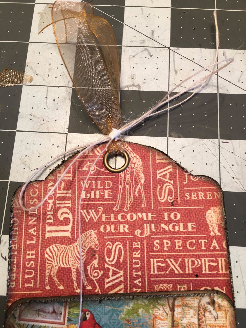 Tie a button string bow over the looped ribbon. To secure the button string and make sure it does not come untied, add a bit of white glue to the center knot.