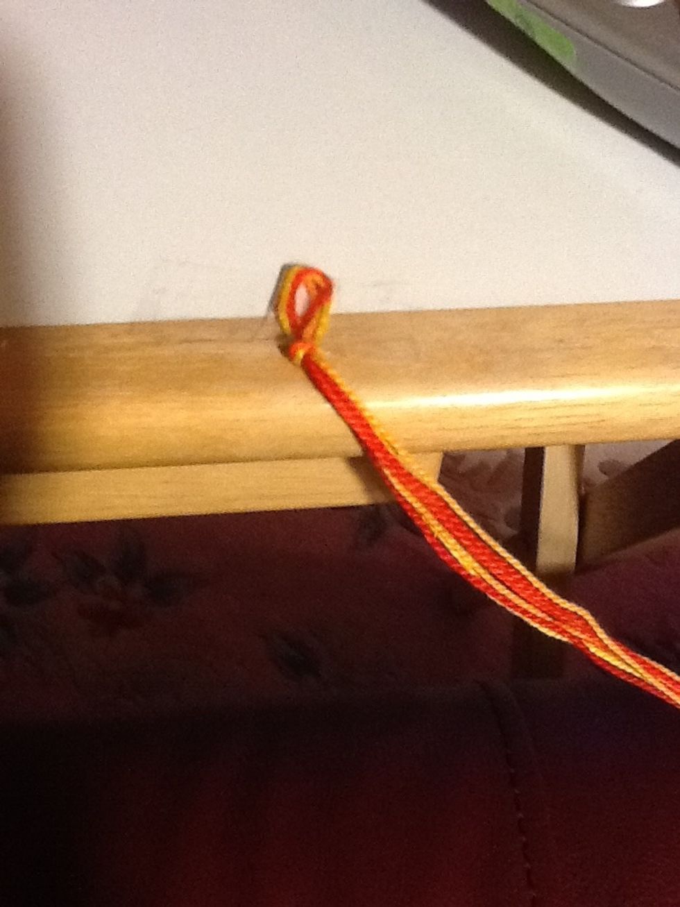 Tie a knot and tape to a table or pin to a pillow.