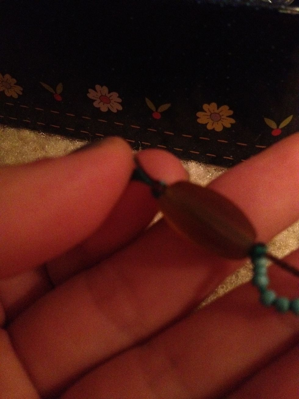Tie a knot at the end of BOTH strings together, and add a round bead(not a long like the pic!) Then tie another to lock it in.Start adding beads:)many little beads ,one big, one big, little beads etc.