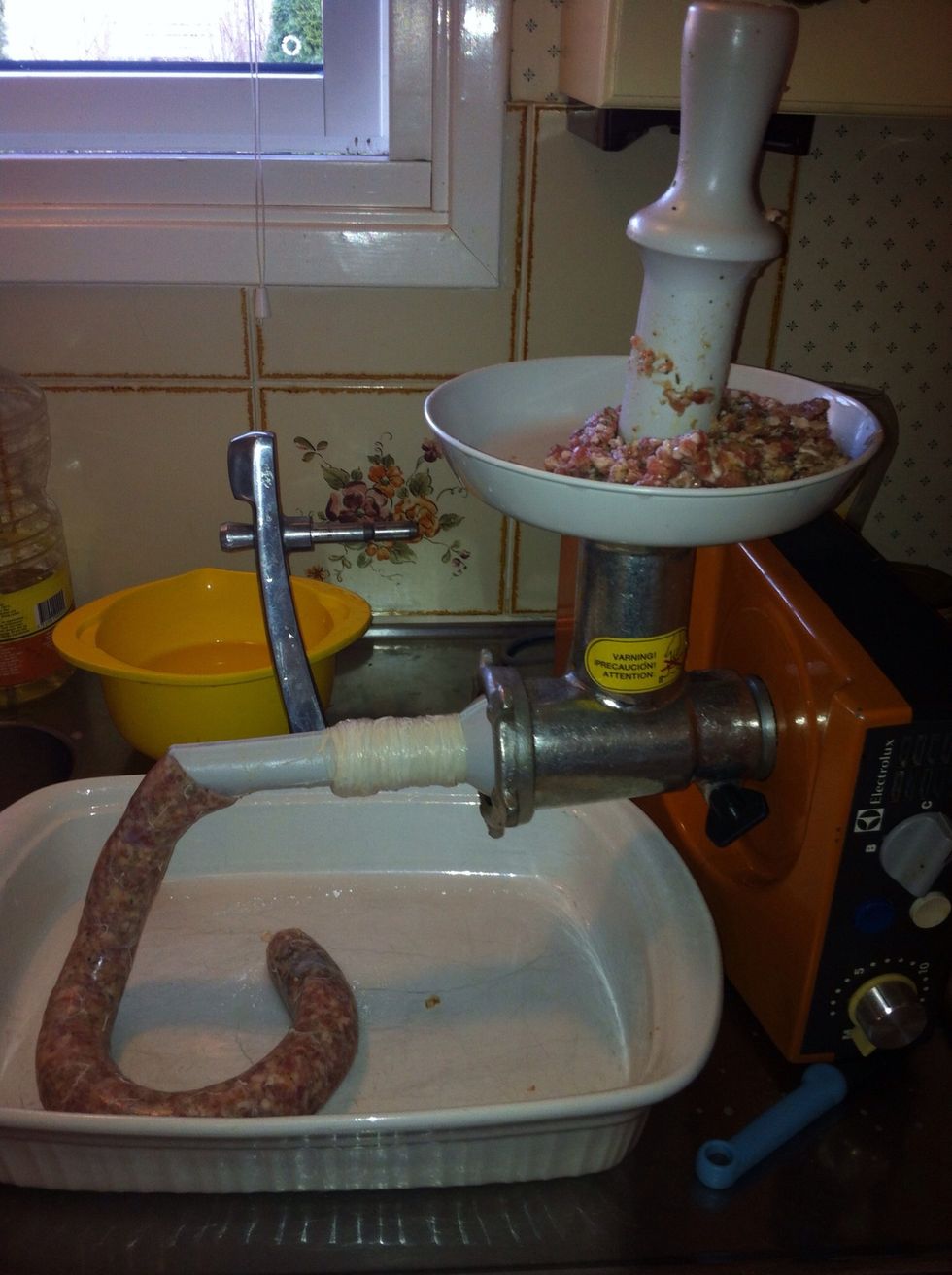 Tie a knot at the end of the casing before you begin and then pierce a hole in the end to release air. Begin stuffing your sausage guiding the casing along the horn. Tie a knot in the finished end.