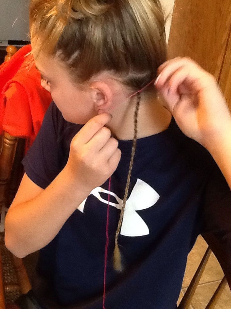 Tie a knot at the top of the braid