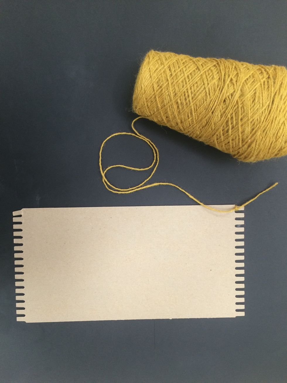 Tie a knot at the top of your board with the yarn.