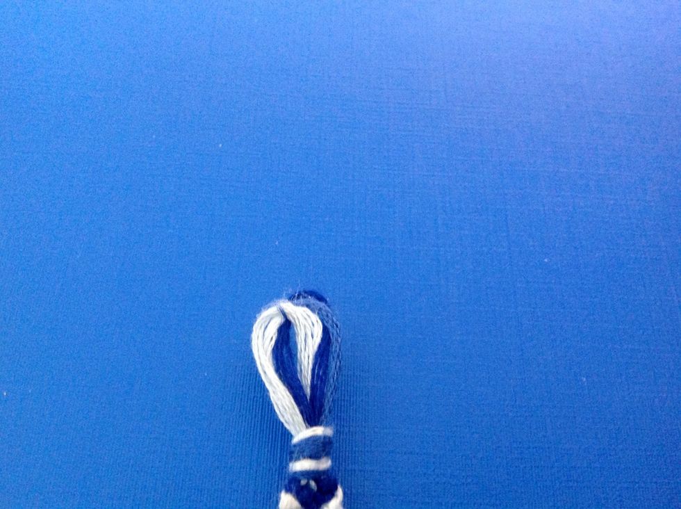 Tie  a knot at the top so it creates a loop. I am using a button to end this bracelet. You will see!