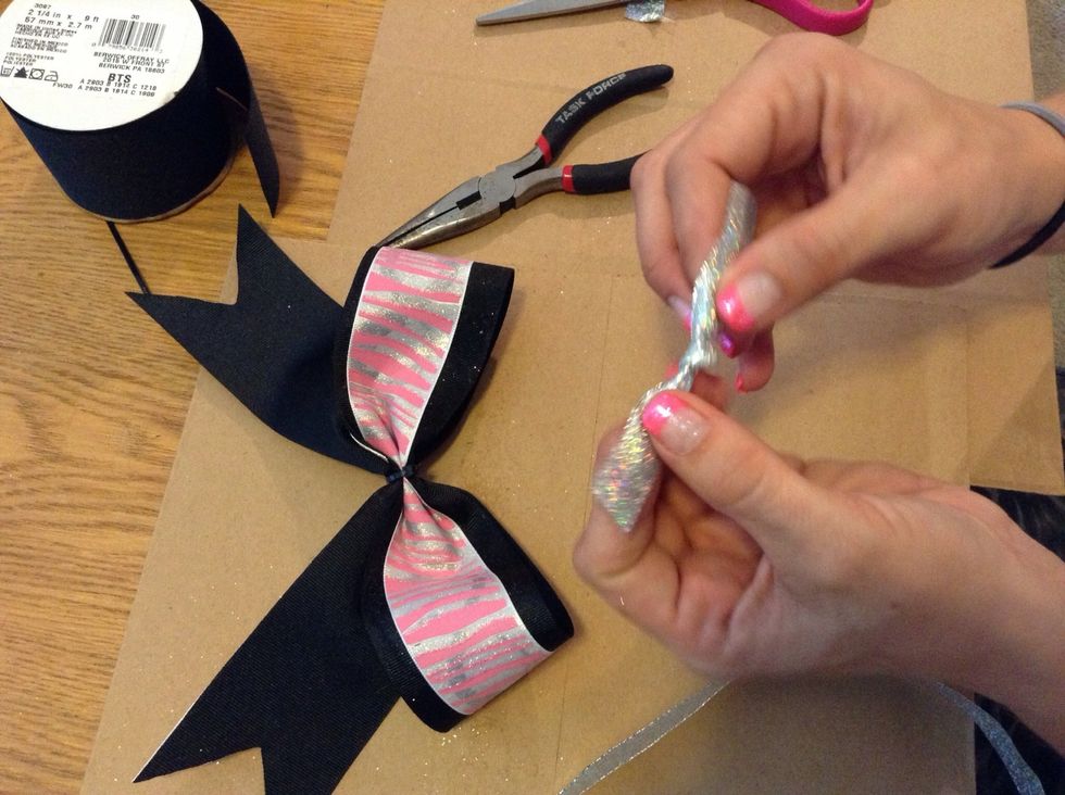 Tie a knot in the center of the fabric/ribbon for the middle of bow. Set aside.