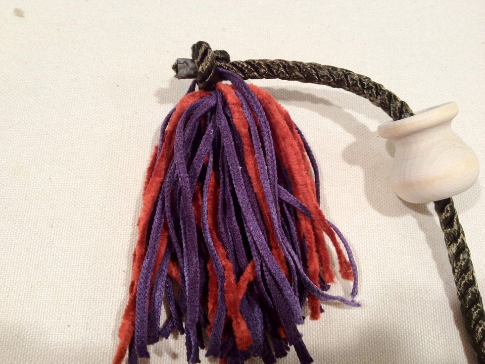 Tie a knot in the cord as shown above.