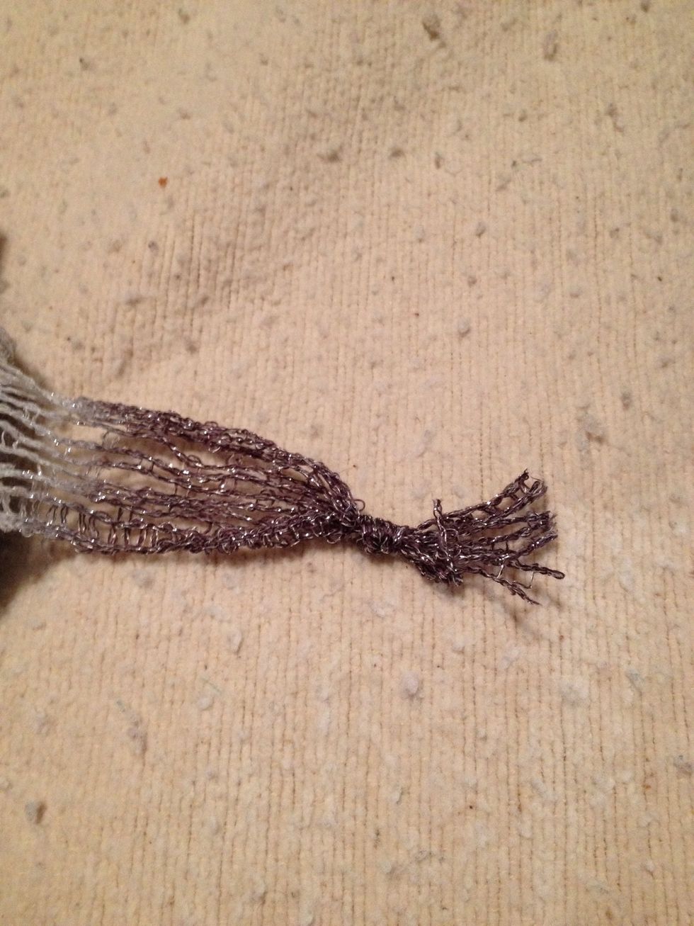 Tie a knot in the end to keep it from unraveling. This gets hidden in the first couple of ruffles, so don't worry about it. You can trim close to the knot if strings hang down.