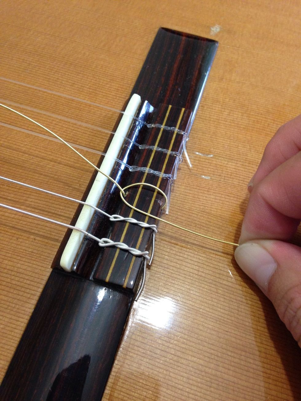 Tie a knot in the string. (See next step).