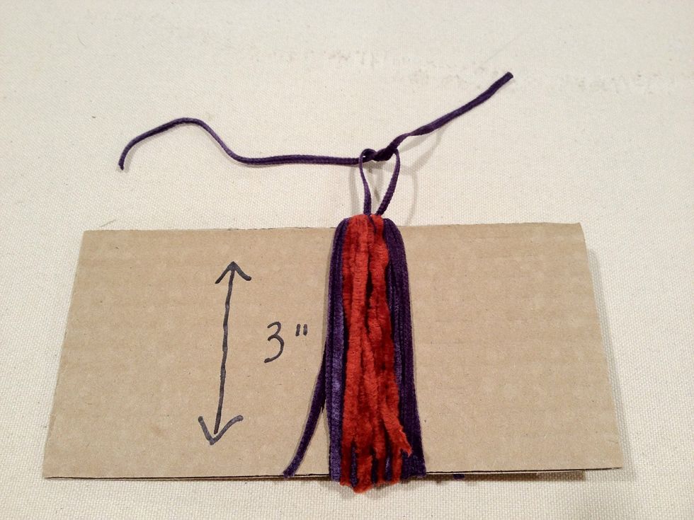 Tie a knot in the yarn at the top as shown.