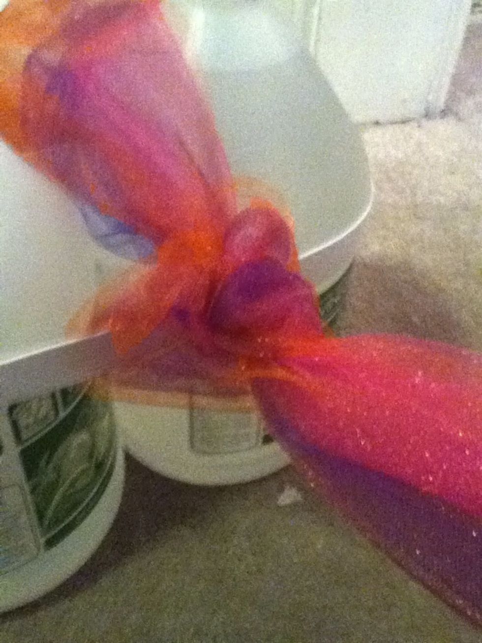 Tie a knot, like you are starting to tie your laces.