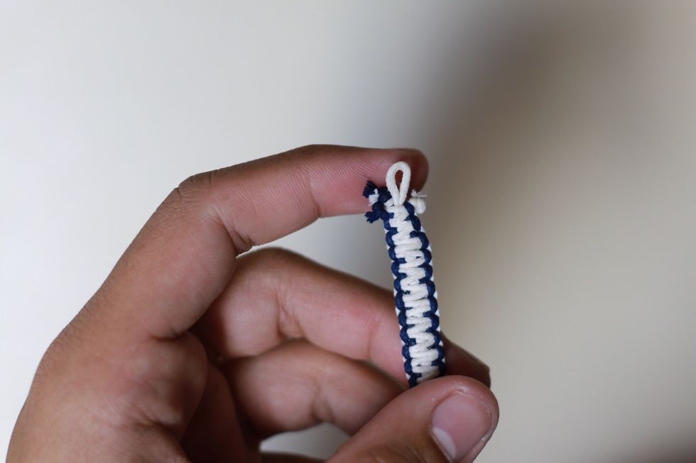 Tie a knot on both side of the string to keep the braid from unraveling. Once done, cut the excess cords off, like so in the pictures.