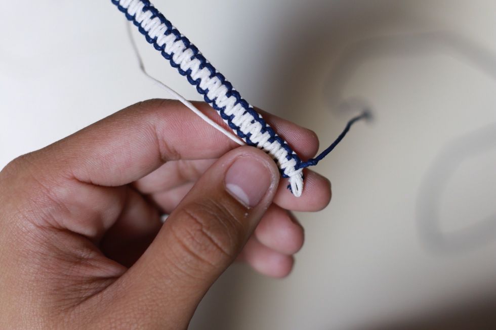 Tie a knot on both side of the string to keep the braid from unraveling.