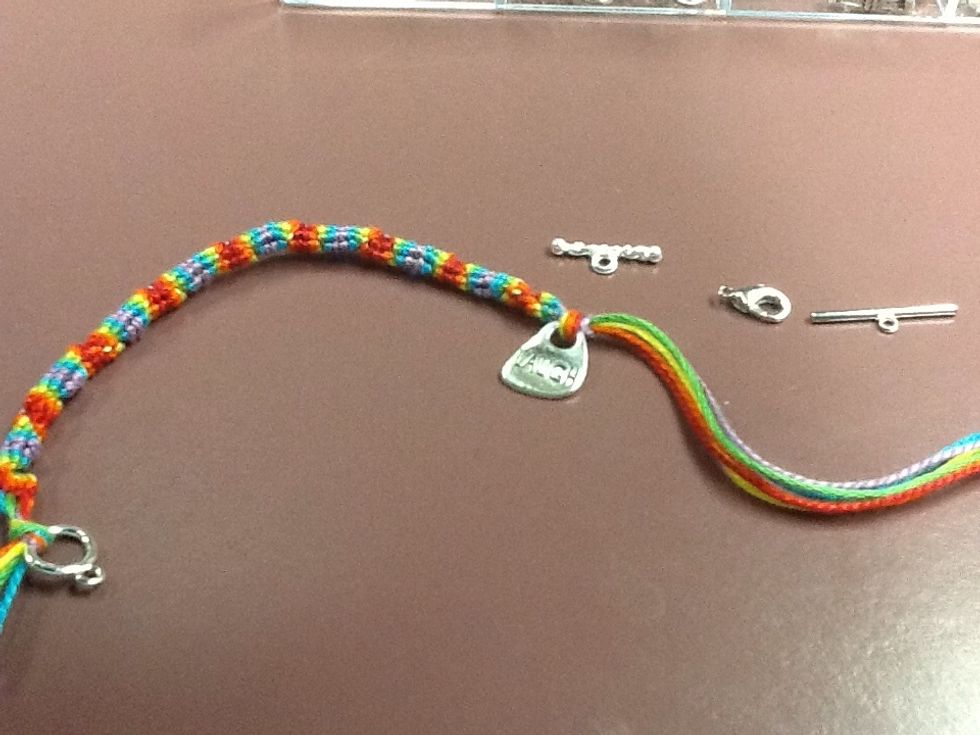 Tie a knot to secure the accessory, then choose a clasp or toggle to add to your bracelet.