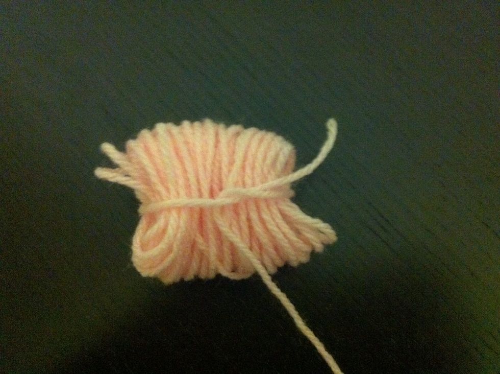 Tie a lose knot across the middle of the coil