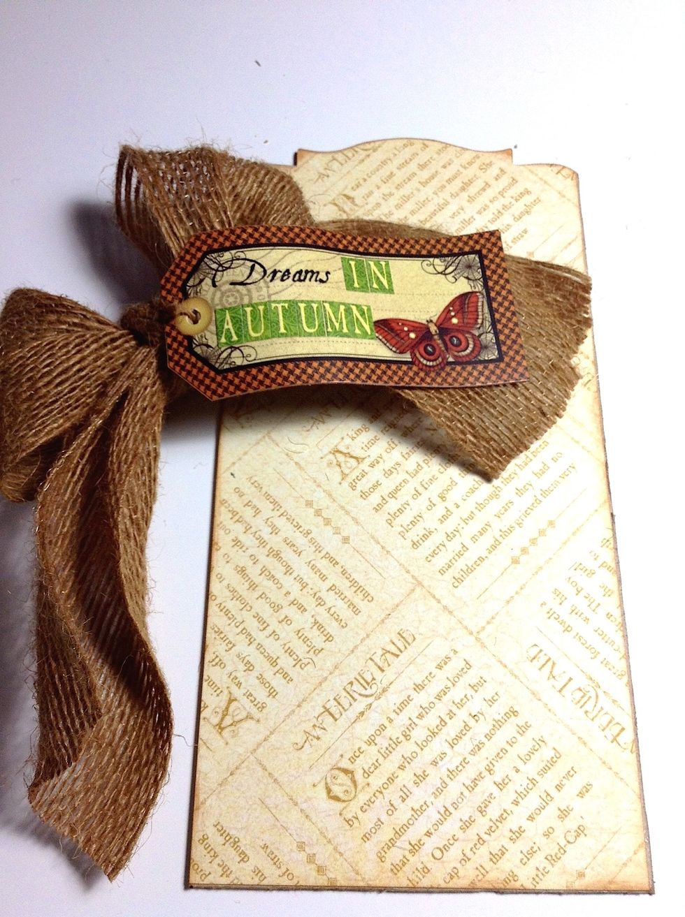 Tie a piece of ribbon into a bow with a sentiment as desired tag and adhere to paper with tacky glue.