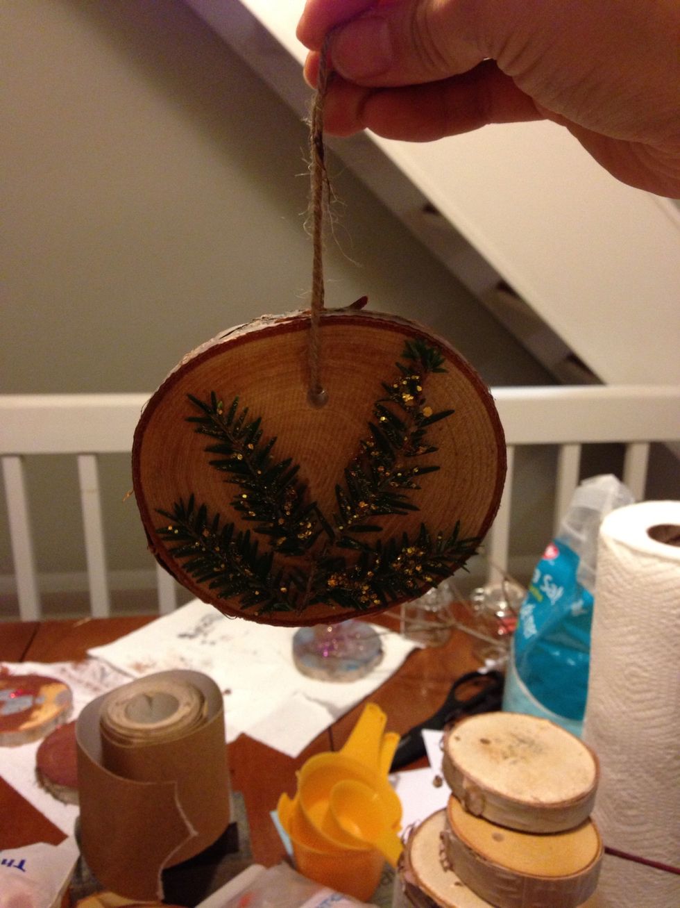 Tie a piece of twine through each hole to create a loop to hang your ornament.