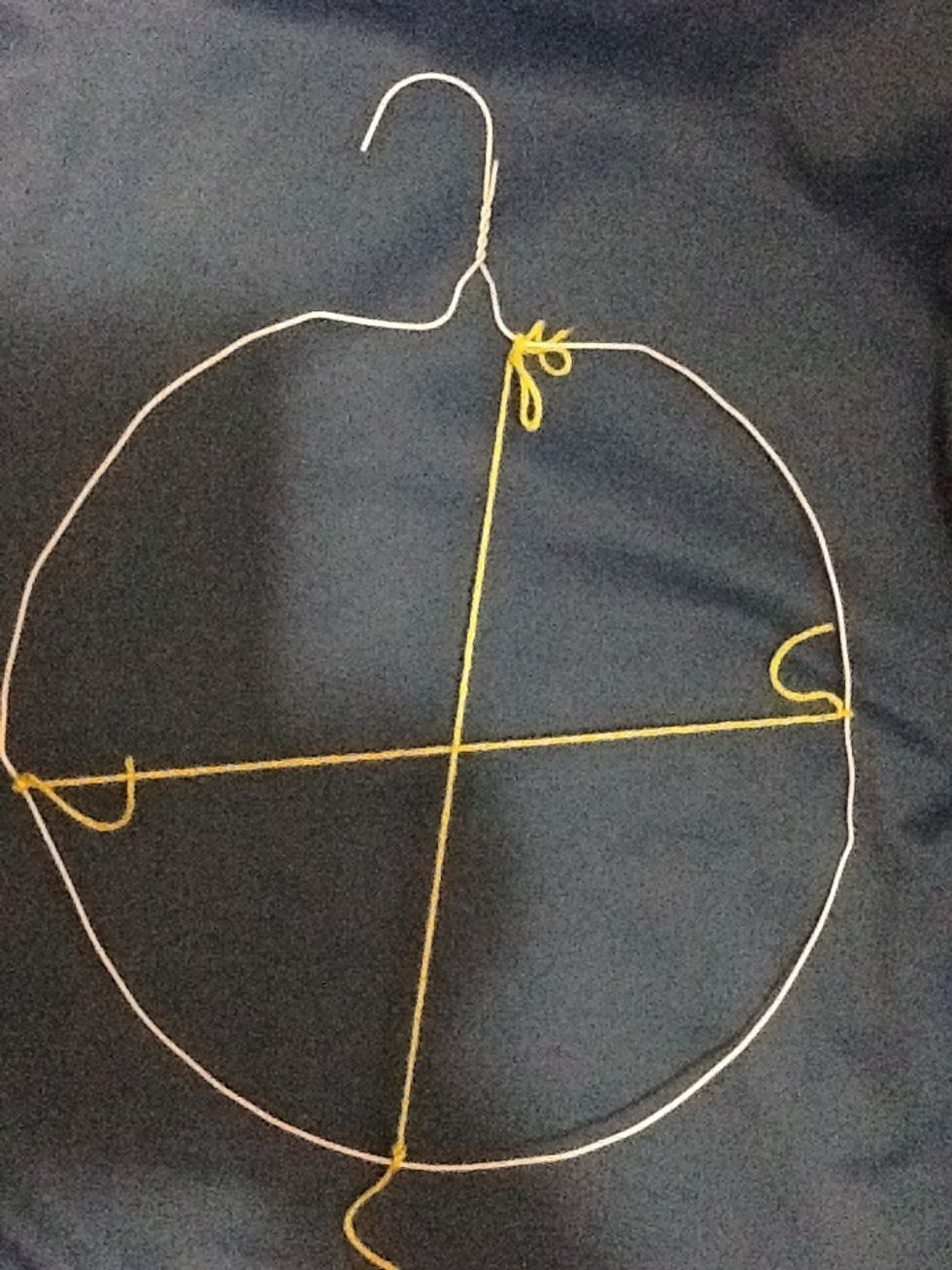 Tie a piece of yarn to cross the first piece (perpendicular).