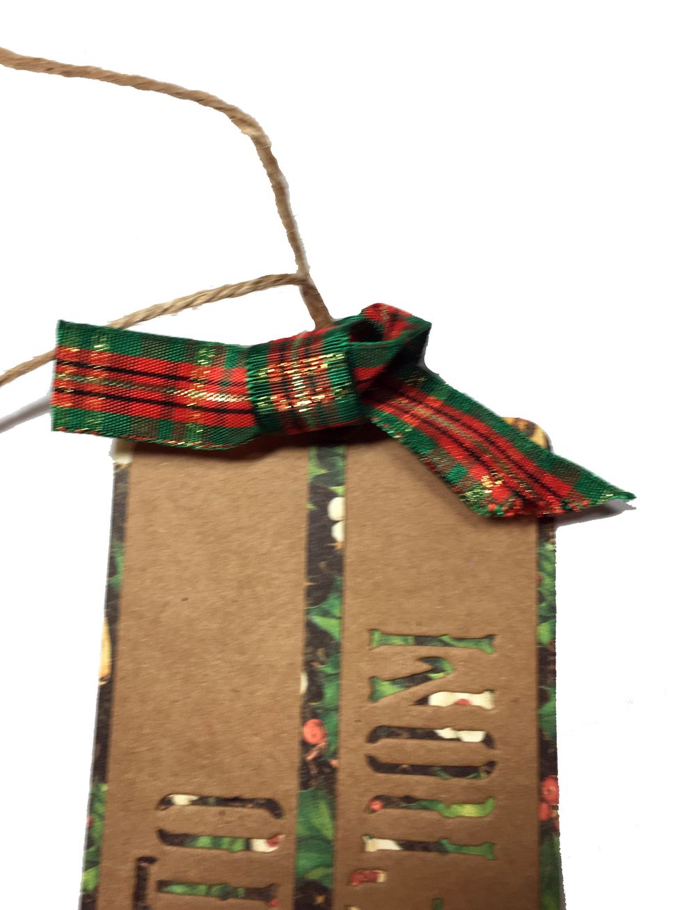 Tie a ribbon on the tag. I just make a single loop like the beginning of tieing a square knot. Run the ribbon through the grommet and bring the front ribbon over the back ribbon making a loop.