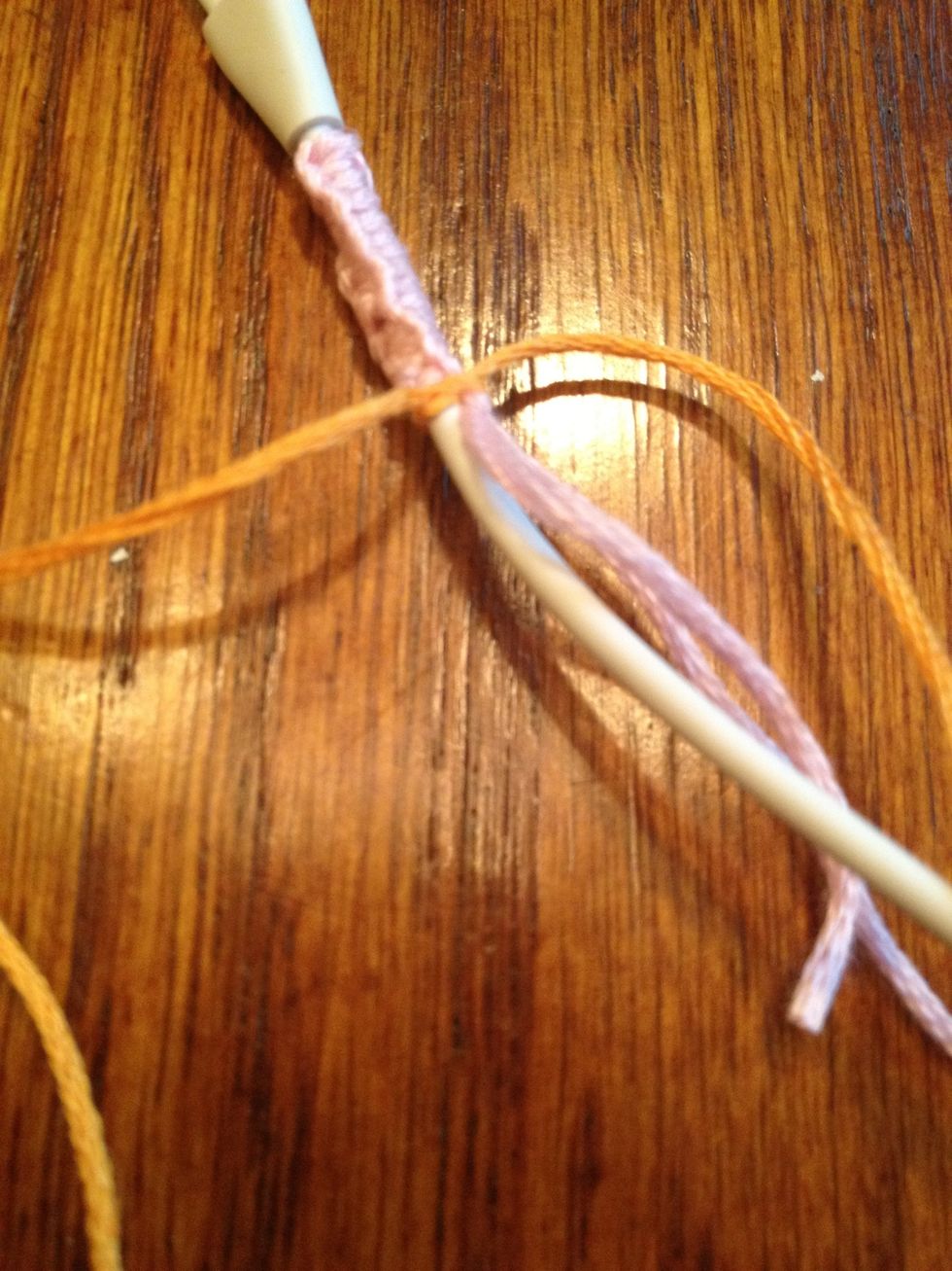 Tie a simple knot to the end of the first color