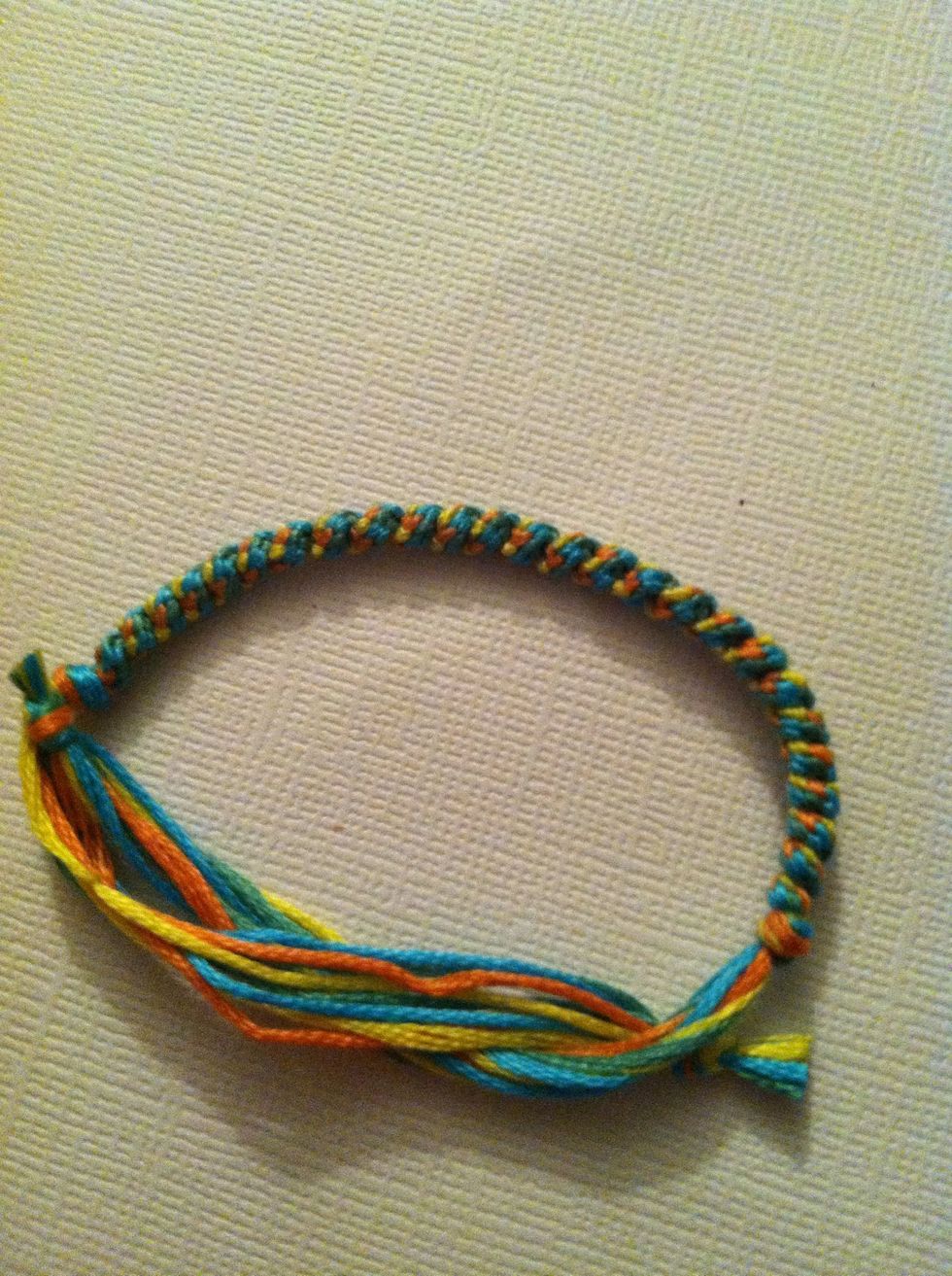 Tie an overhand knot again, tighten both ends. Fix your ends how you'd like. And you're done. So this was how I did mine, I like the pattern better.