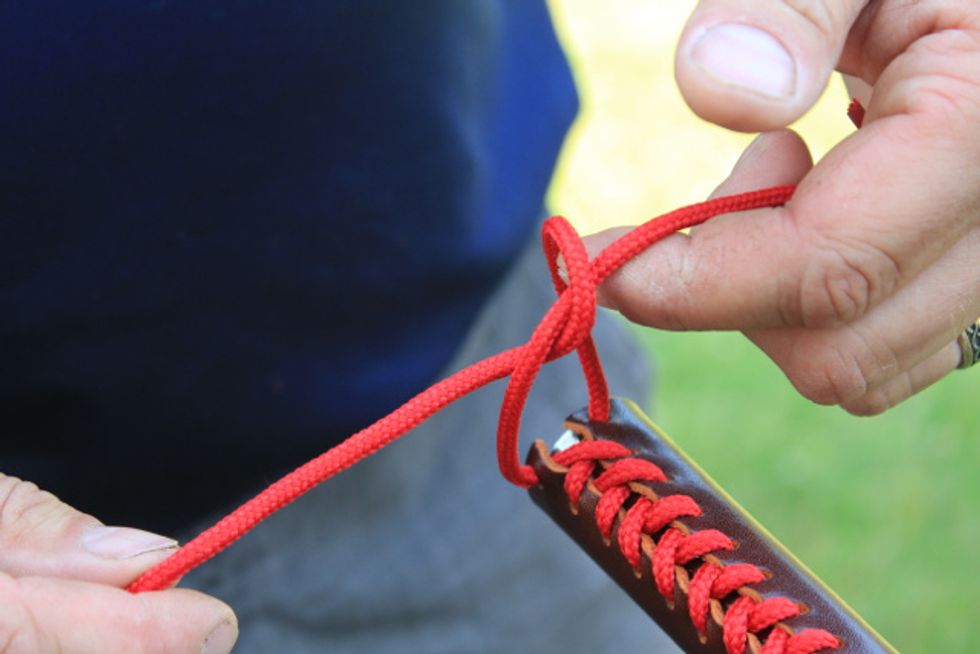Tie an overhand knot and pull tight.
