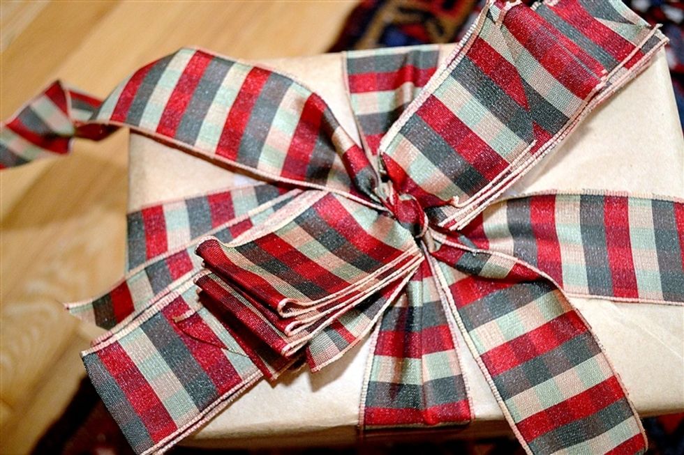 Tie another knot at the notches with the ribbon that is wrapped around the package.