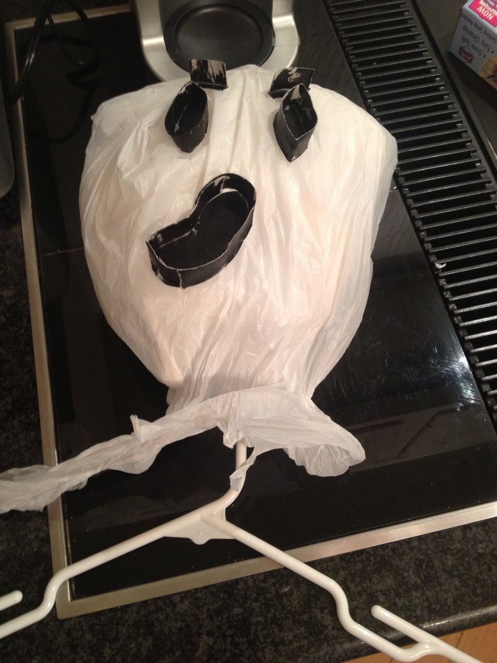 Tie head to hanger. Tape or staple paper and or other bags to hanger to make chest and then body. *extra tips Pull and stretch plastic to make more realist texture and attach string to various areas.
