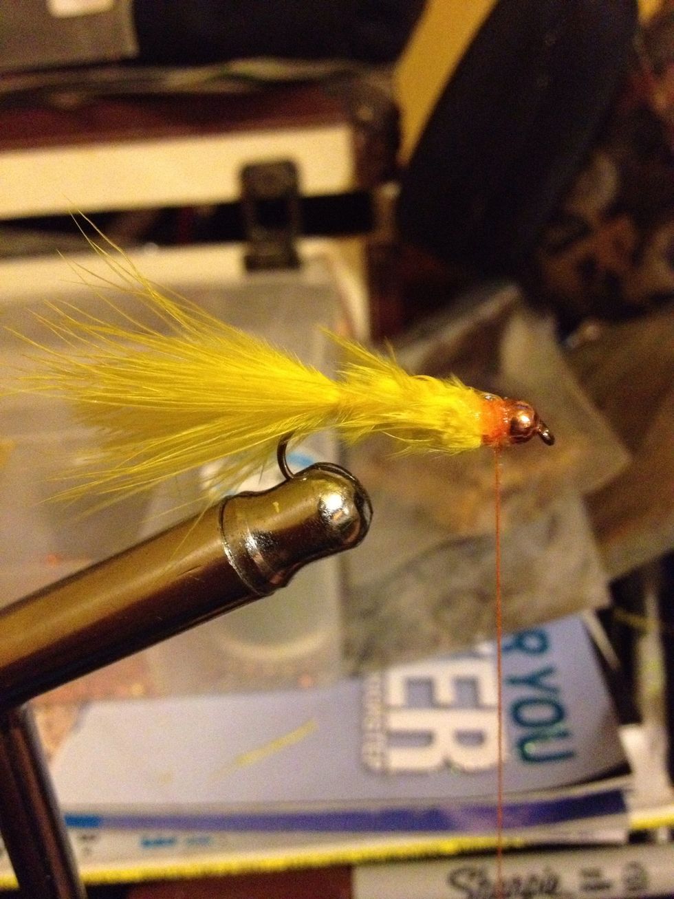 Tie off the feather, trim any excess and build a head behind the bead. Whip finish and secure with head cement.