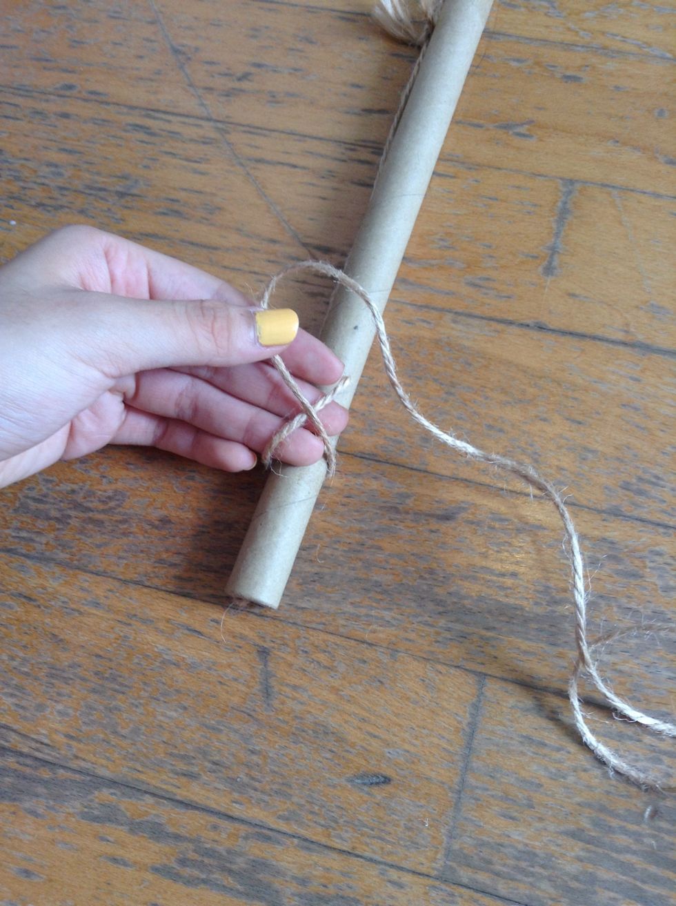 Tie one end of each long string to the rod.