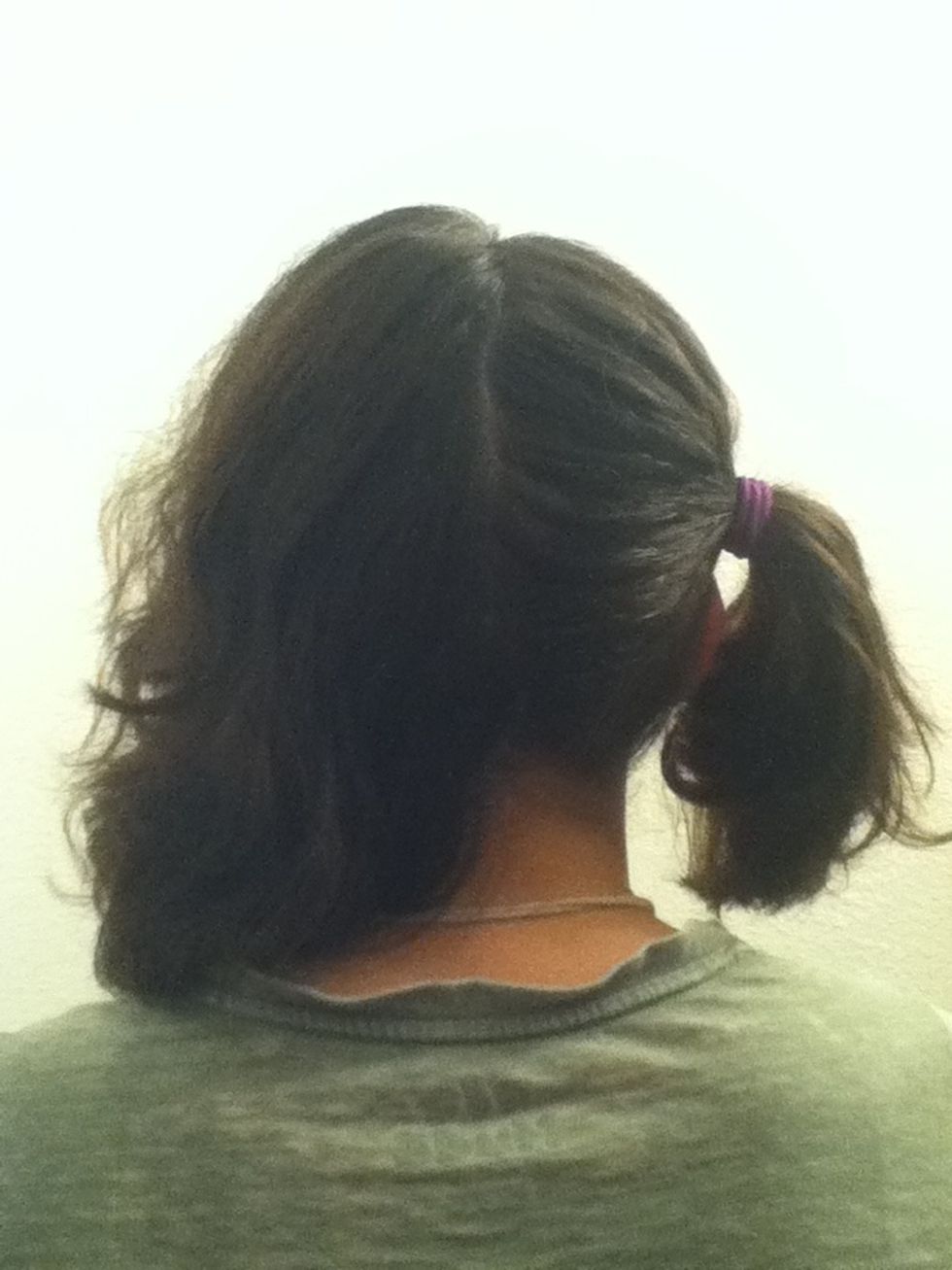 Tie one side over with a pony tail so it's out of the way. Clip your bangs to that side to keep them from getting in your face while trying to work.