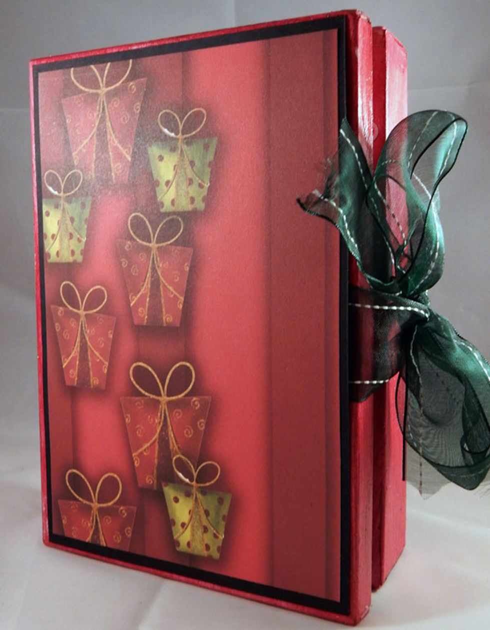 Tie ribbon around the box.  Add cardstock and pattern paper to the front and back to finish the book and also hold the ribbon in place.