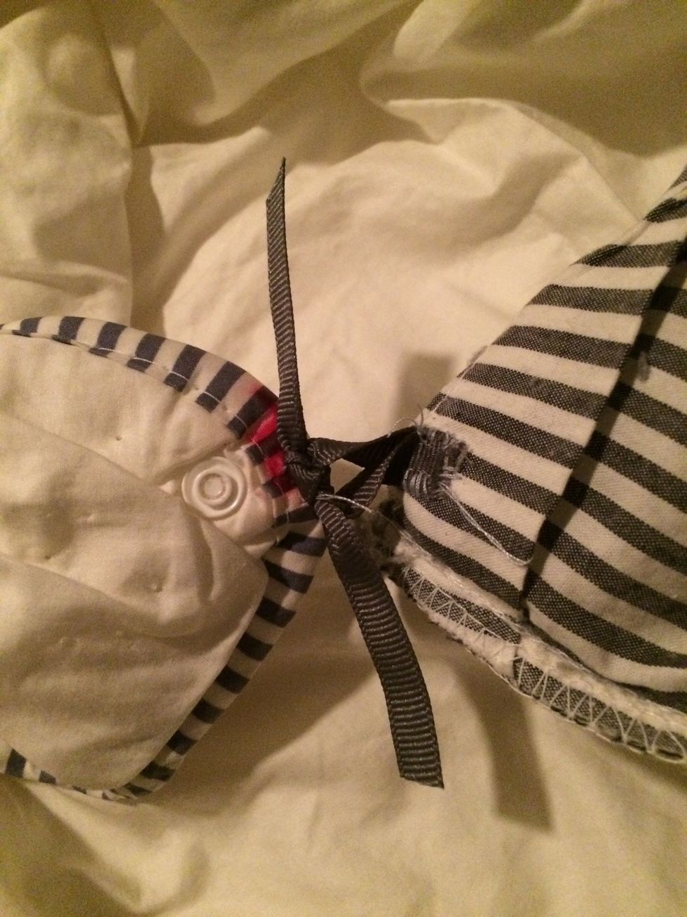 Tie the long piece, thru the loop. If you have an extra long ribbon for the tie, you can tie a bow for ease of undoing later. I used short ties and just double knotted. (A single knot doesn't stay)