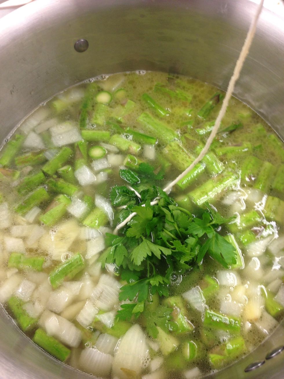 Tie the parsley and add to the pot as well. Put the pot back in the oven for another 15 minutes.