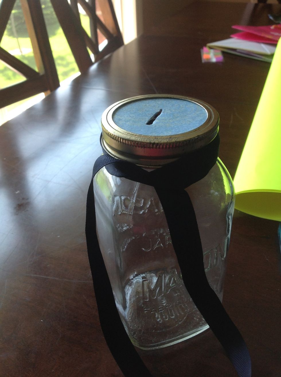 Tie the ribbon around the top of the jar.