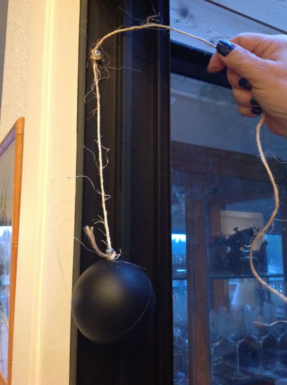 Tie the twine around the screw about 10" from the ball.