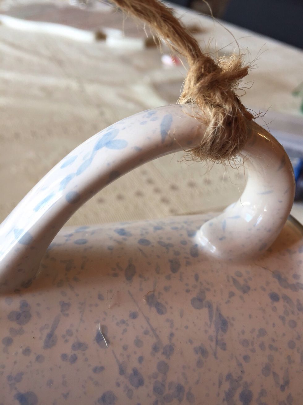 Tie the twine securely around the mug handle.