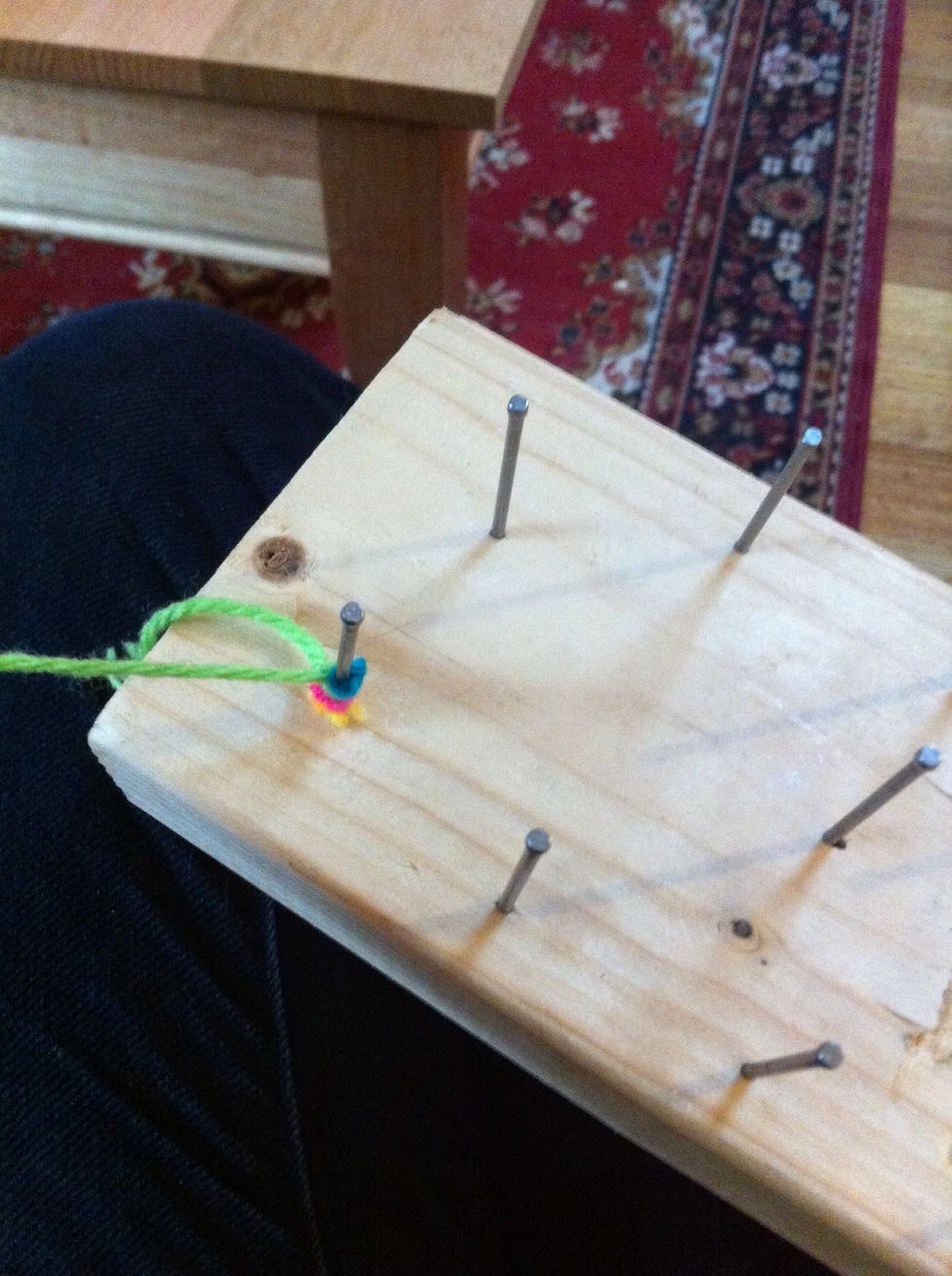 Tie the wood around a nail, I used a double knot.