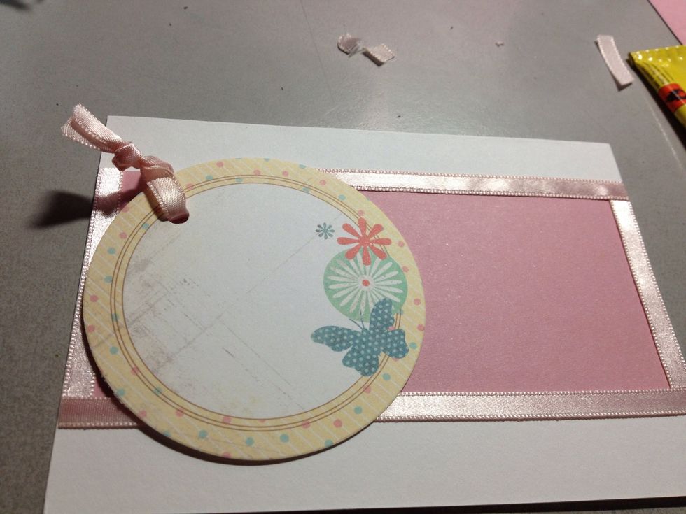 Tie up the ribbon (it's too short because the tag can't dangle properly like a normal gift tag). Glue down some ribbon on the top border, except near to the hole.