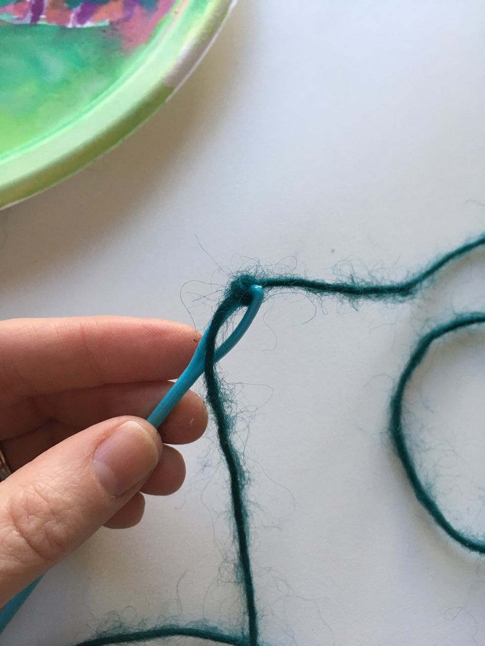 Tie yarn to needle.